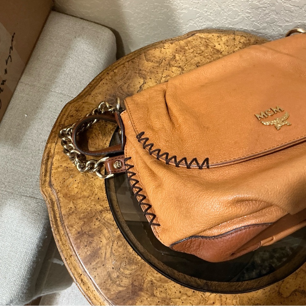 MCM shoulder bag in a tan or cognac featuring gathered flap and whipstitch trim - Picture 7 of 9